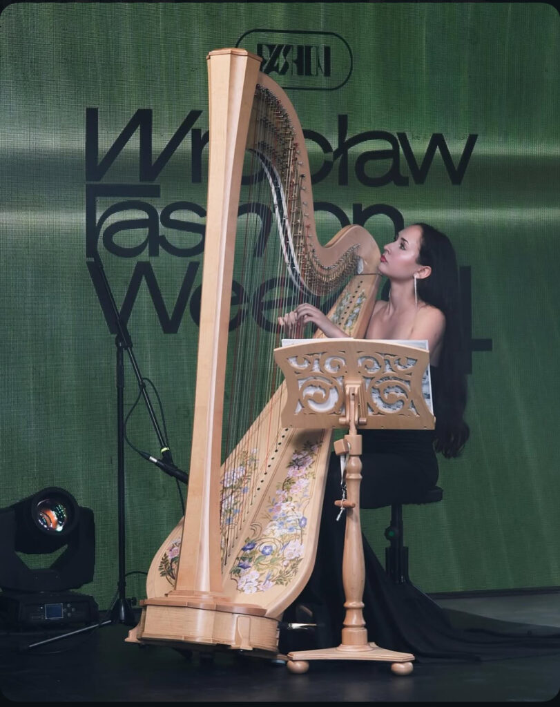 Harpist Krystyna Siek performing live at a fashion show